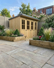 Abwood Summerhouse with steel roof and Georgian windows beside raised timber planters