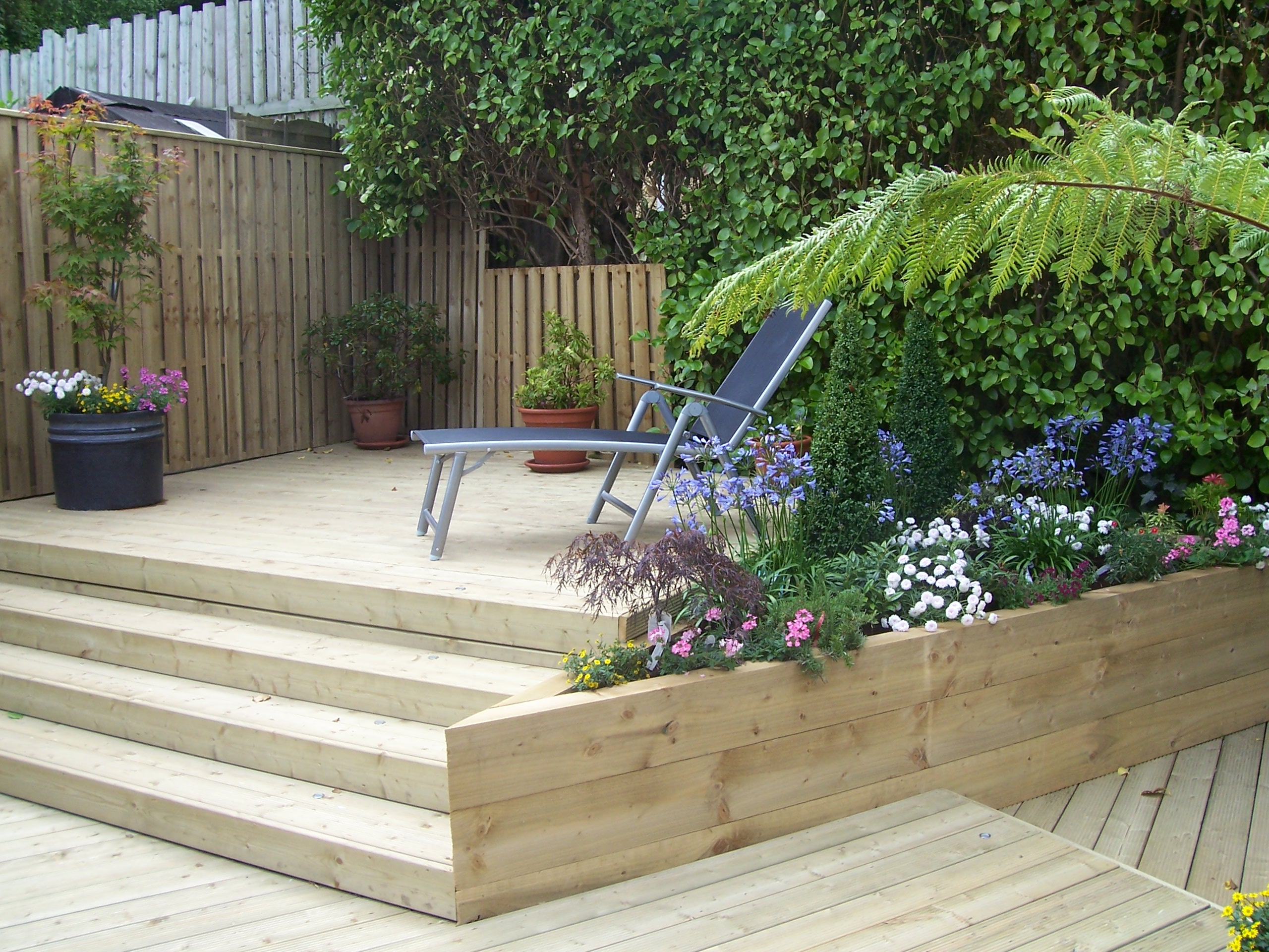 Timber decking with steps and chairs Abwood Homes